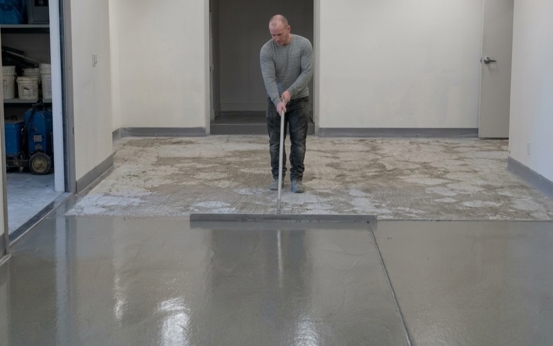 A warehouse slab in Killeen mid-polish, one half refined to a satin finish and the other still unworked.